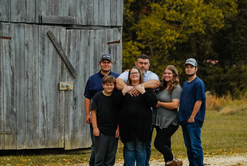 The family behind Rust & Grain Vintage Market standing beside a rustic barn