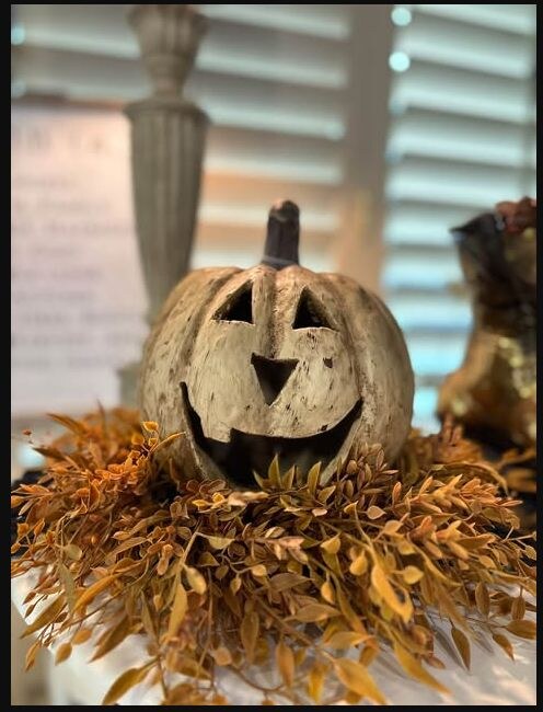 Seasonal jack-o-lantern décor at a Rust & Grain market